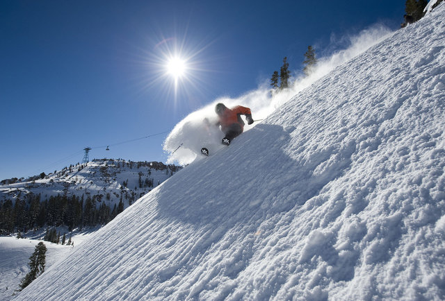 dude skiing kicking up snow