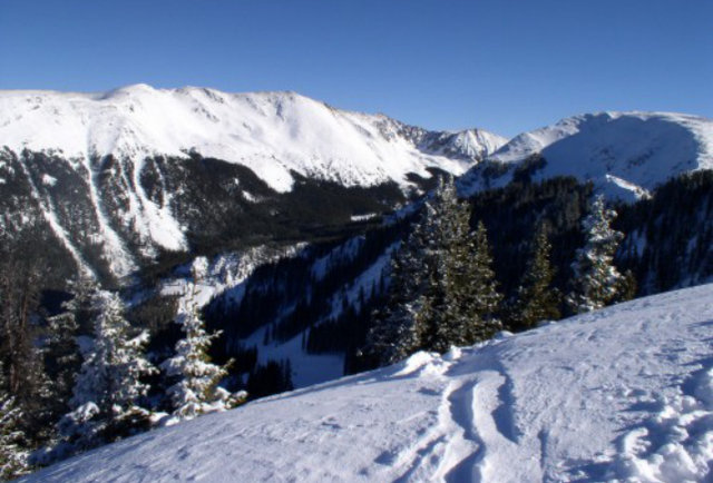 snow-covered mountain looking down into valley